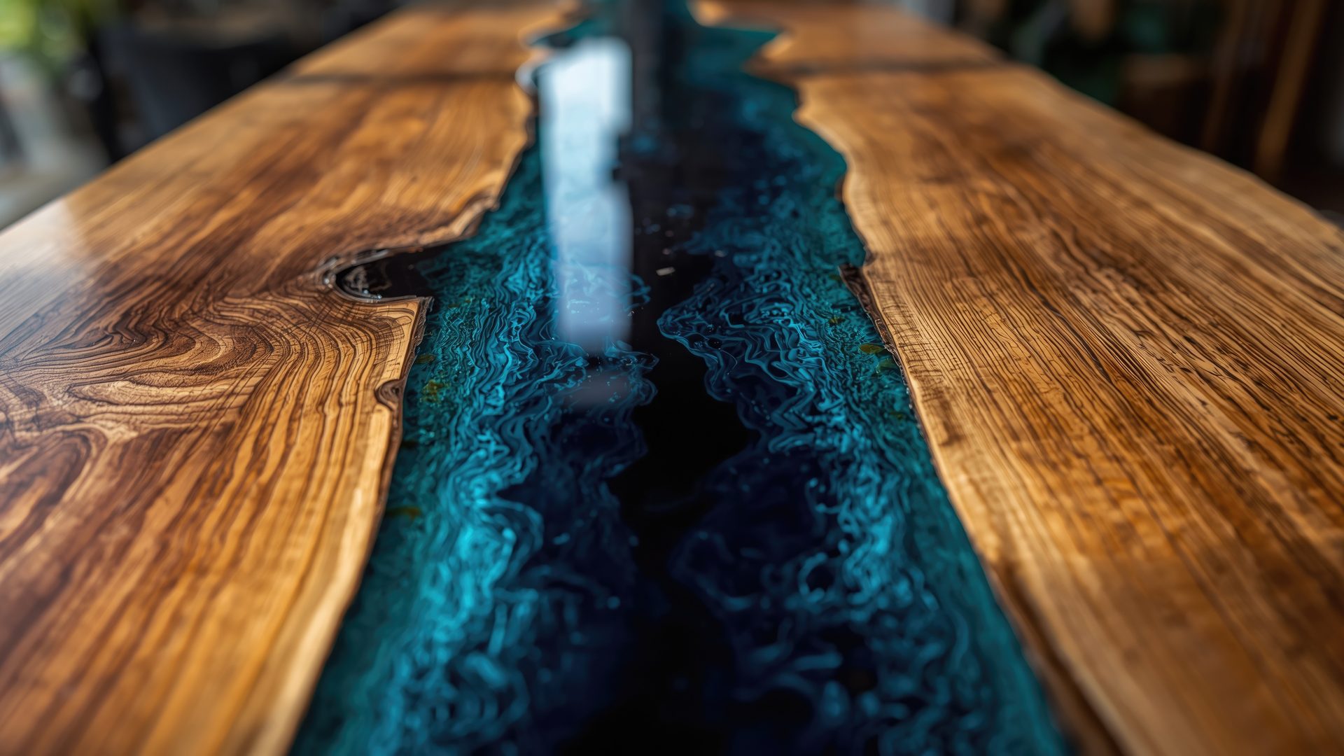 Warm hardwood dining table with a deep ocean-blue epoxy river running its length